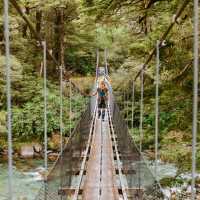 Crossing one of the swing bridges on the trail