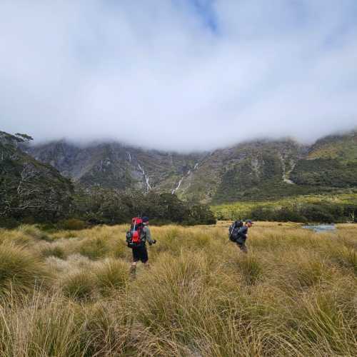 Trekkers enjoying the solitude and rugged terrain of Lake Nerine