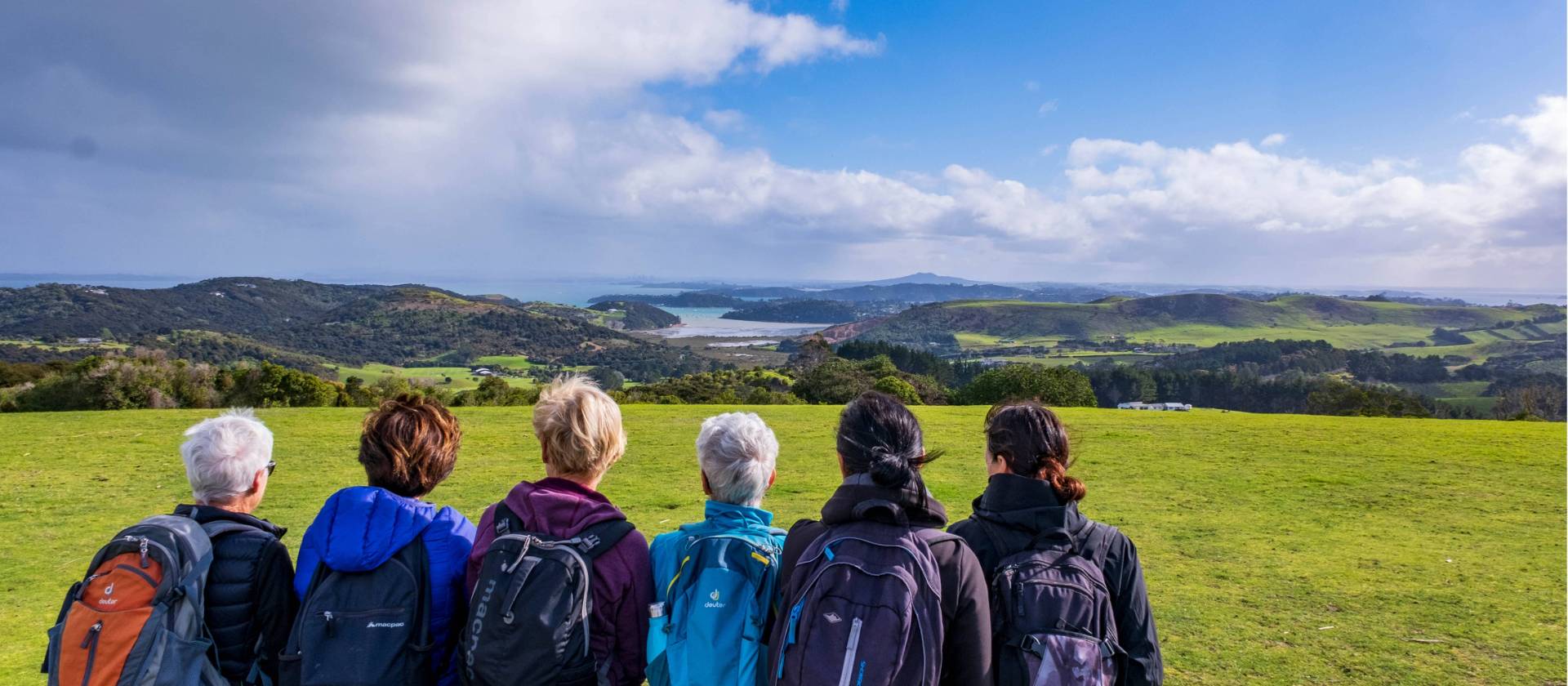 A group of Te Ara Hura walkers stop to take a break and admire the view | Gabrielle Young