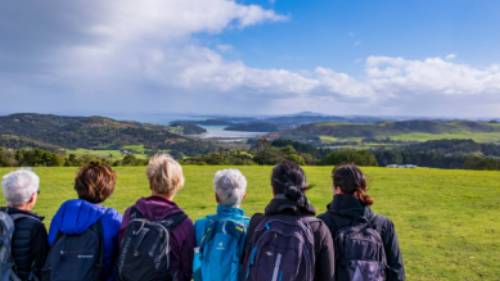 A group of Te Ara Hura walkers stop to take a break and admire the view | Gabrielle Young