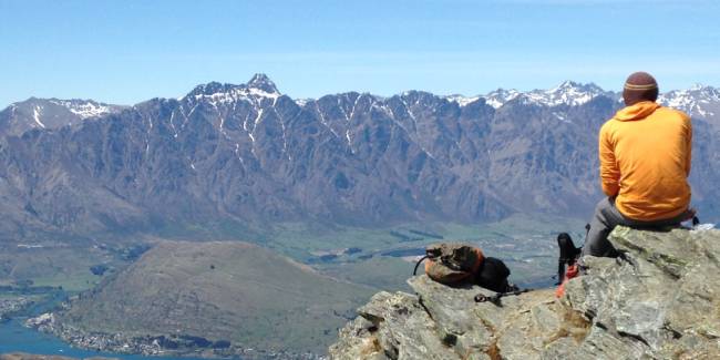 A hiker enjoying the views on top of Ben Lomond summit