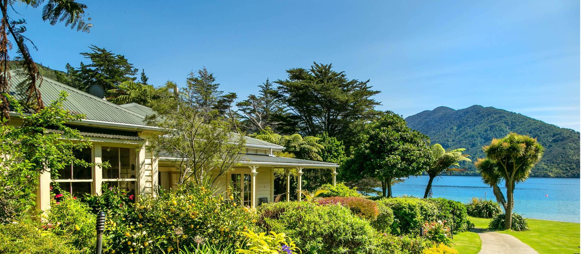 Lovely garden setting of Mahana Lodge in Endeavour Inlet | Mahana Lodge