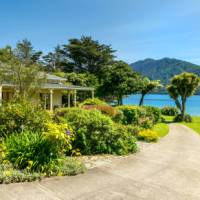 Lovely garden setting of Mahana Lodge in Endeavour Inlet | Mahana Lodge