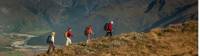 Trekkers on Buchanan peak with Mount Aspiring behind, walking above Matukituki valley, near Lake Wanaka |  <i>Colin Monteath</i>
