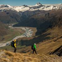 Trekkers on Buchanan peak with Mount Aspiring behind, walking above Matukituki valley, near Lake Wanaka |  <i>Colin Monteath</i>