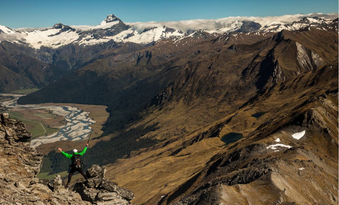 Trekker on Buchanan peak with Mount Aspiring behind, walking above Matukituki valley, near Lake Wanaka | <i>Colin Monteath</i>